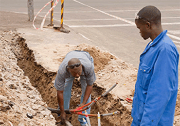 Workers drilling holes for electrical wiring